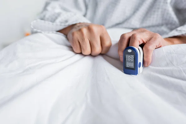 stock image Cropped view of pulse oximeter on hand of senior man in hospital 