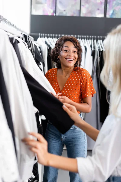 Vreugdevolle Afrikaan Amerikaanse Vrouw Zoek Naar Wazig Vriend Kiezen Kleding — Stockfoto