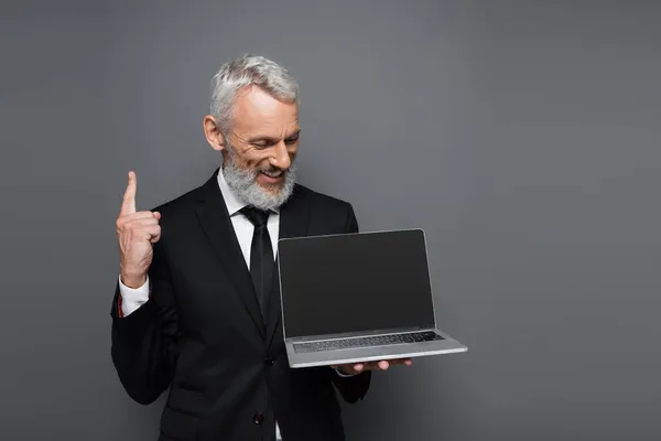Happy Middle Aged Businessman Suit Holding Laptop Blank Screen Pointing — Stock Photo, Image