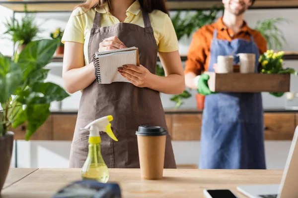 Cropped View Florist Writing Notebook Coffee Devices Plant Flower Shop — Stock Photo, Image