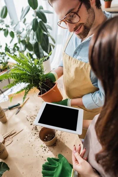 Young Florist Holding Digital Tablet Blank Screen Smiling Colleague Plant — Stock Photo, Image