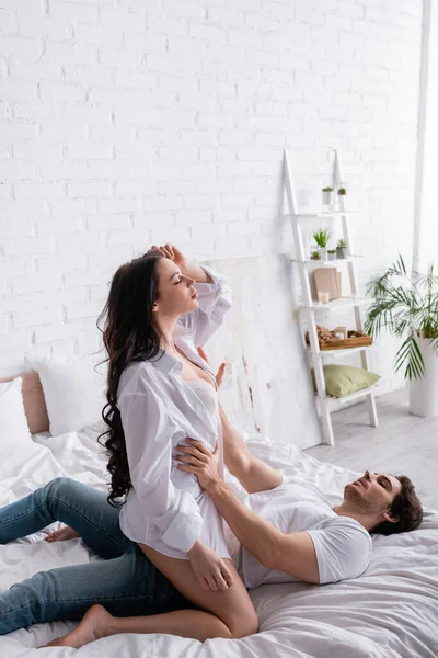 Passionate Woman Closed Eyes Unbuttoned Shirt Seducing Man Bedroom — Stock Photo, Image