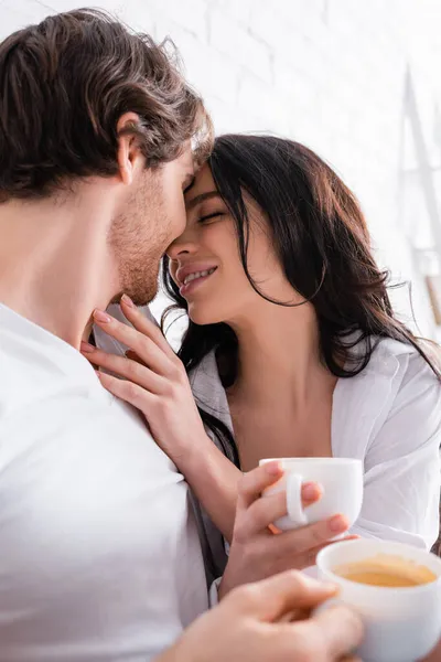 Sensual Brunette Woman Young Man Holding Coffee While Embracing Bedroom — Stock Photo, Image
