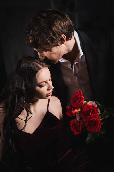 Young Man Holding Red Roses Elegant Brunette Woman Dark Background — Stock Photo, Image