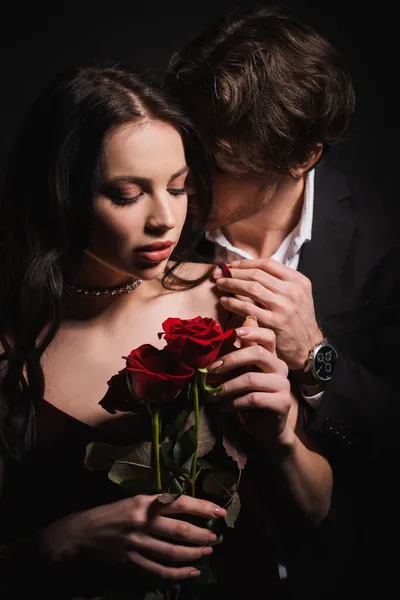 Young Man Embracing Shoulder Seductive Woman Holding Red Roses Isolated — Stock Photo, Image