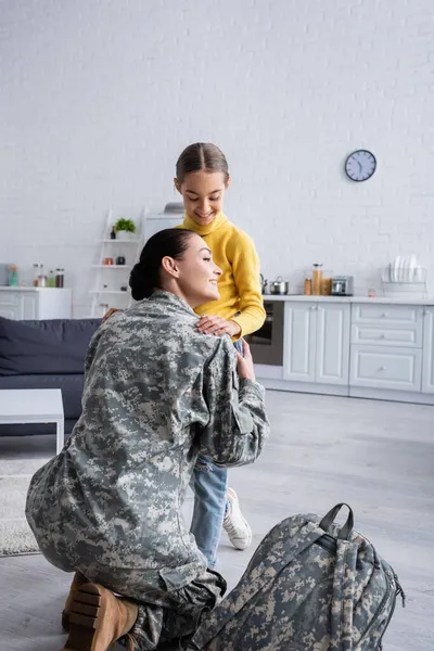 Smiling Woman Hugging Child Military Backpack Home — Stock Photo, Image