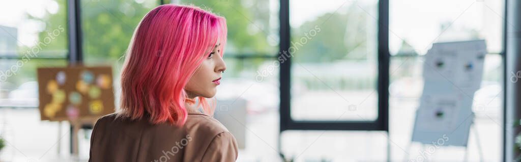 young manager with pink hair and piercing in office, banner