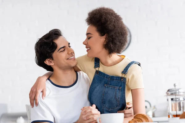 Happy Multiethnic Couple Holding Hands While Looking Each Other Breakfast — Stock Photo, Image