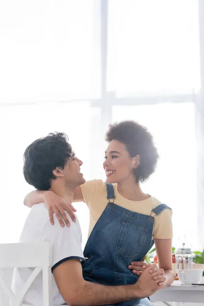 Happy Multiethnic Couple Hugging While Looking Each Other Breakfast — Stock Photo, Image