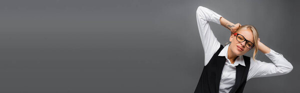 Young businesswoman suffering from headache isolated on grey, banner 