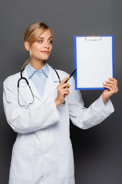 Young Doctor Pointing Clipboard Copy Space Isolated Grey — Stock Photo, Image