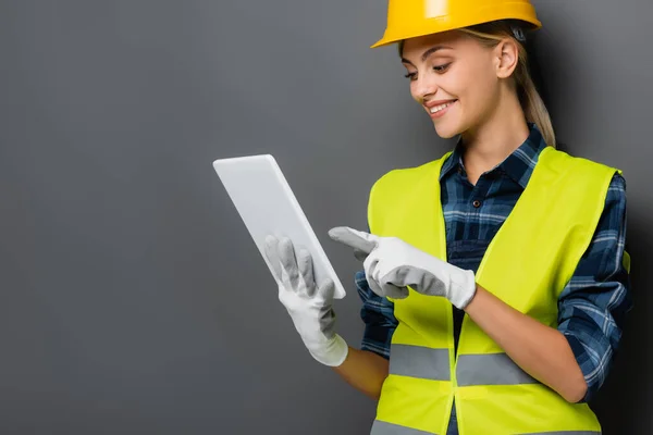 Smiling Blonde Builder Safety Vest Gloves Pointing Digital Tablet Isolated — Stock Photo, Image