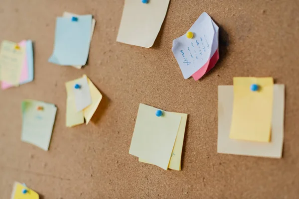 Colorful sticky notes on board in office