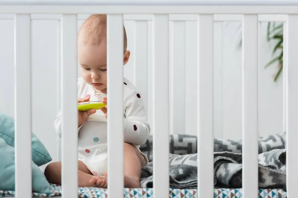 Toddler Boy Sitting Crib Playing Rattle Ring — Stock Photo, Image