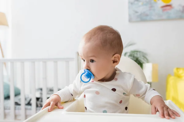 赤ん坊の椅子に座っているペースメーカーを持つ幼児 — ストック写真
