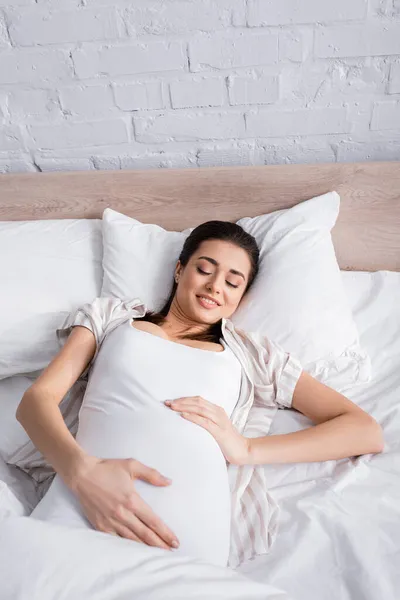 Ξύπνια Έγκυος Γυναίκα Αγγίζει Την Κοιλιά Ενώ Ξαπλώνει Στο Κρεβάτι — Φωτογραφία Αρχείου