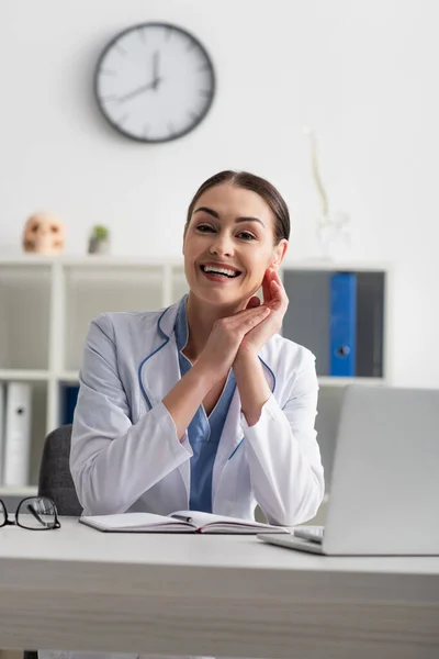 Happy Doctor Looking Camera While Sitting Blurred Laptop — Stock Photo, Image