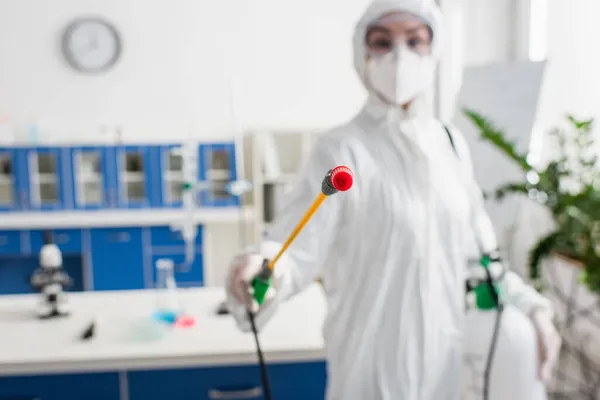 Blurred Scientist Protective Suit Holding Sprayer While Cleaning Laboratory — Stock Photo, Image