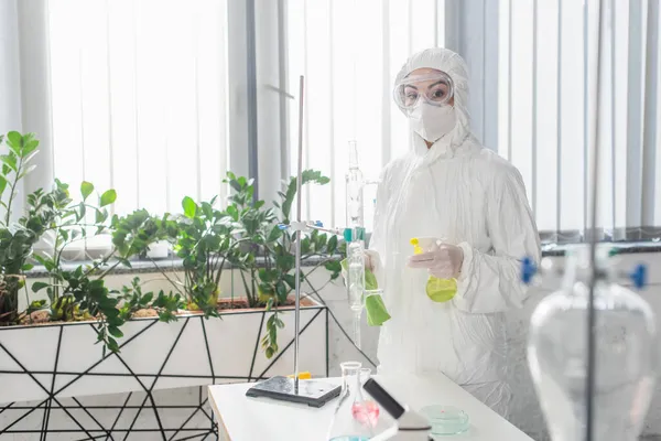 Doctor Hazmat Suit Holding Rag Spray Bottle While Looking Camera — Stock Photo, Image