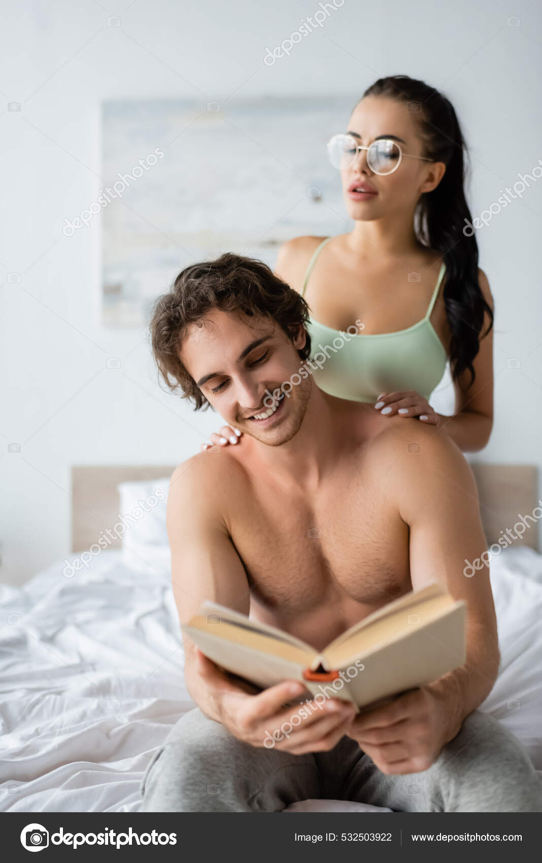 Smiling Shirtless Man Reading Book Sexy Girlfriend Bed Home Stock Photo by ©HayDmitriy 532503922