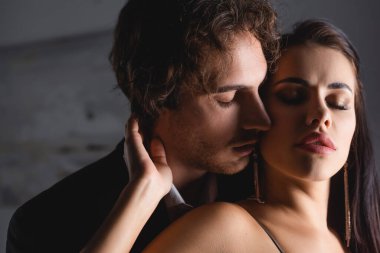 Resmi kıyafetli bir adam gece evde baştan çıkarıcı bir kız arkadaş giyer. 