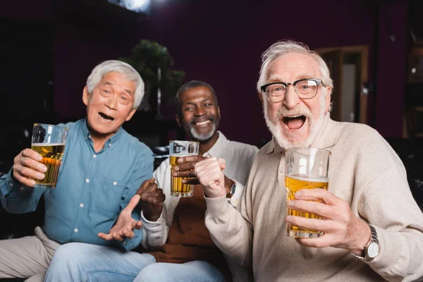 Excited Senior Multicultural Friends Showing Win Gesture While Watching Football — Stock Photo, Image