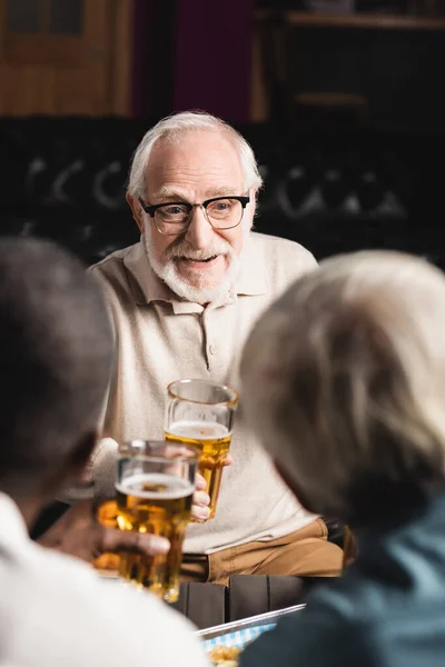 Senior Man Bril Glimlachend Terwijl Hij Een Glas Bier Vasthoudt — Stockfoto