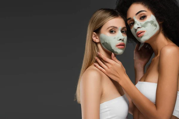 Multiethnic Woman White Tops Clay Masks Posing Isolated Grey — Stock Photo, Image