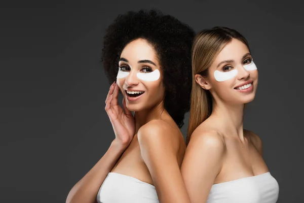 Smiling Multiethnic Women White Tops Eye Patches Looking Camera Isolated — Stock Photo, Image