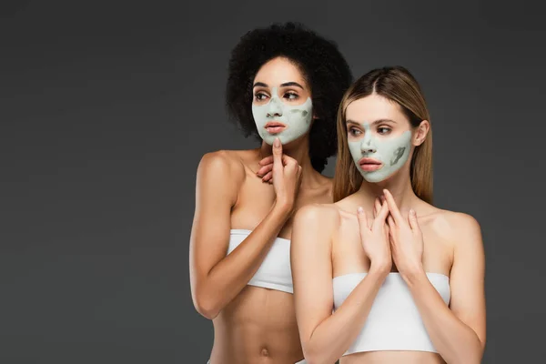 Slim Interracial Women White Tops Clay Masks Standing Isolated Grey — Stock Photo, Image