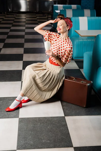 Happy Pin Woman Holding Milkshake While Sitting Suitcase Cafe — Stok Foto