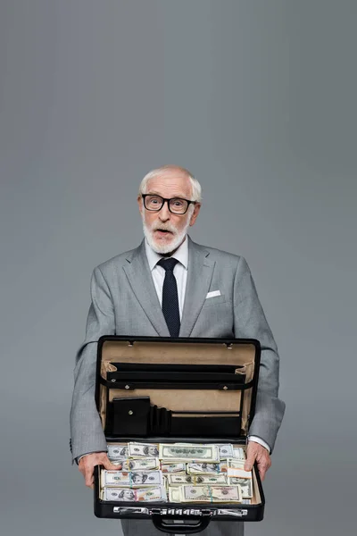Amazed Senior Businessman Showing Briefcase Full Dollars Isolated Grey — Stock Photo, Image