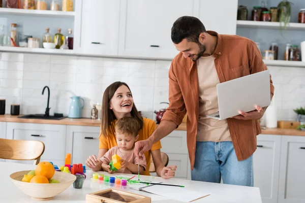 Hombre Sosteniendo Portátil Dibujo Cerca Esposa Hijo Cocina — Foto de Stock