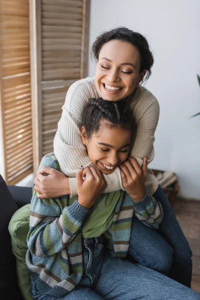 Cheerful African American Woman Teenage Daughter Embracing Closed Eyes Home — Stock Photo, Image