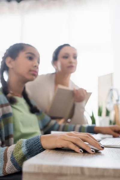 Teenage African American Girl Doing Homework Mother Book Blurred Background — Stock Photo, Image