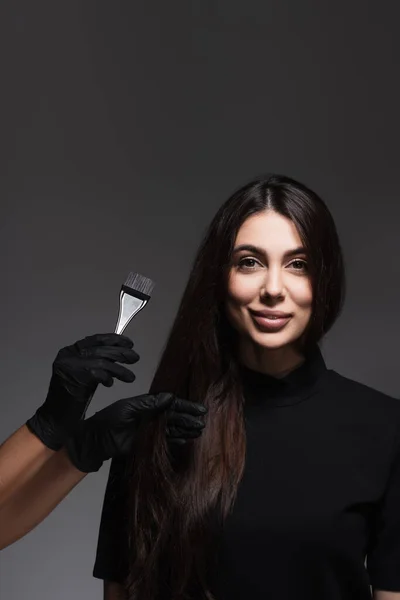 Hairstylist Holding Brush Cheerful Woman Brown Hair Isolated Dark Grey — Stock Photo, Image