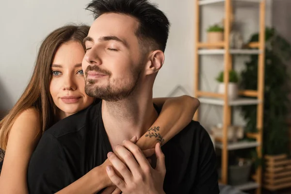 Happy Tattooed Woman Hugging Boyfriend Black Shirt Sitting Closed Eyes — Stok fotoğraf