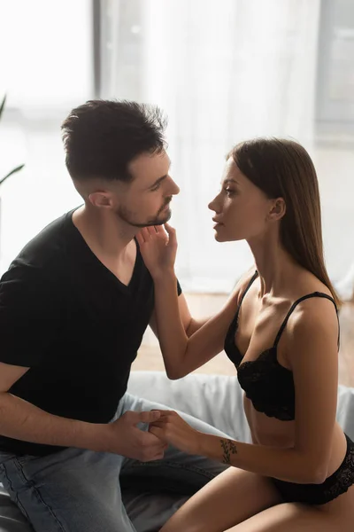 Passionate Woman Touching Face Boyfriend Holding Her Hand Bedroom — 스톡 사진