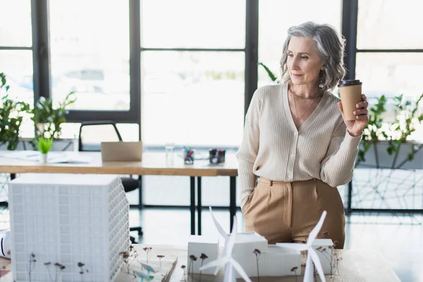 Mature Businesswoman Holding Coffee Models Buildings Office — Stock Photo, Image