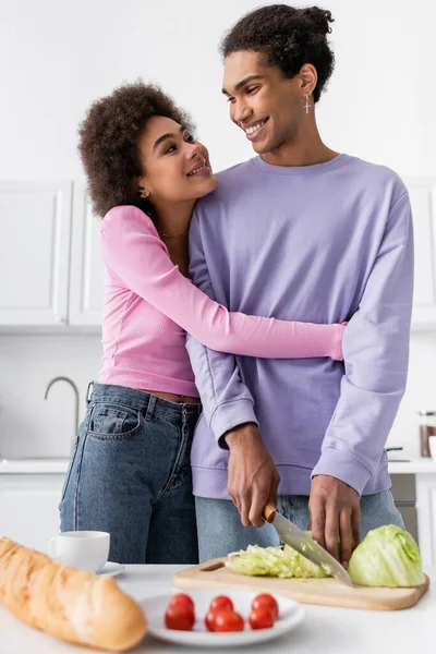 Smiling African American Woman Hugging Boyfriend Cutting Cabbage Kitchen — Stock Photo, Image