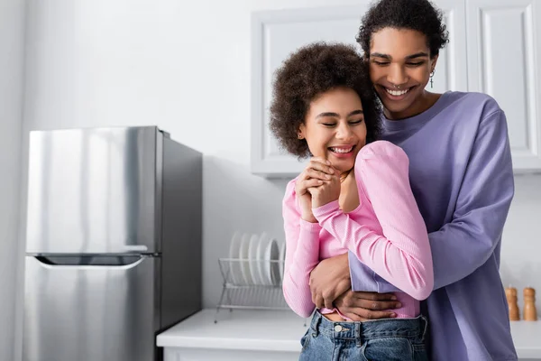 Happy African American Man Hugging Girlfriend Kitchen — Stock Photo, Image