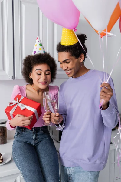 Sonriente Hombre Afroamericano Sosteniendo Globos Champán Tintineo Con Novia Sosteniendo — Foto de Stock