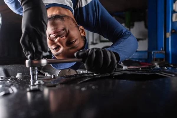 Smiling African American Mechanic Gloves Working Wrench Car Service — Stock Photo, Image