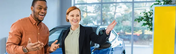 Smiling Car Dealer Pointing Hand Astonished African American Client Banner — Fotografia de Stock