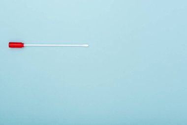 top view of swab test on blue background with copy space, omicron variant concept