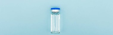 top view of vaccine jar on blue background, omicron variant concept, banner