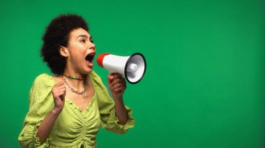 african american woman screaming in loudspeaker isolated on green clipart