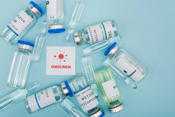 Top View White Card Red Omicron Lettering Bacteria Vaccine Vials — Stok fotoğraf