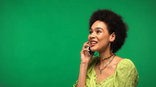 Cheerful African American Woman Blouse Talking Smartphone Isolated Green — стоковое фото