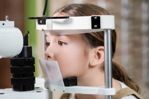 女孩在模糊的视力筛选器上检查视力 — 图库照片